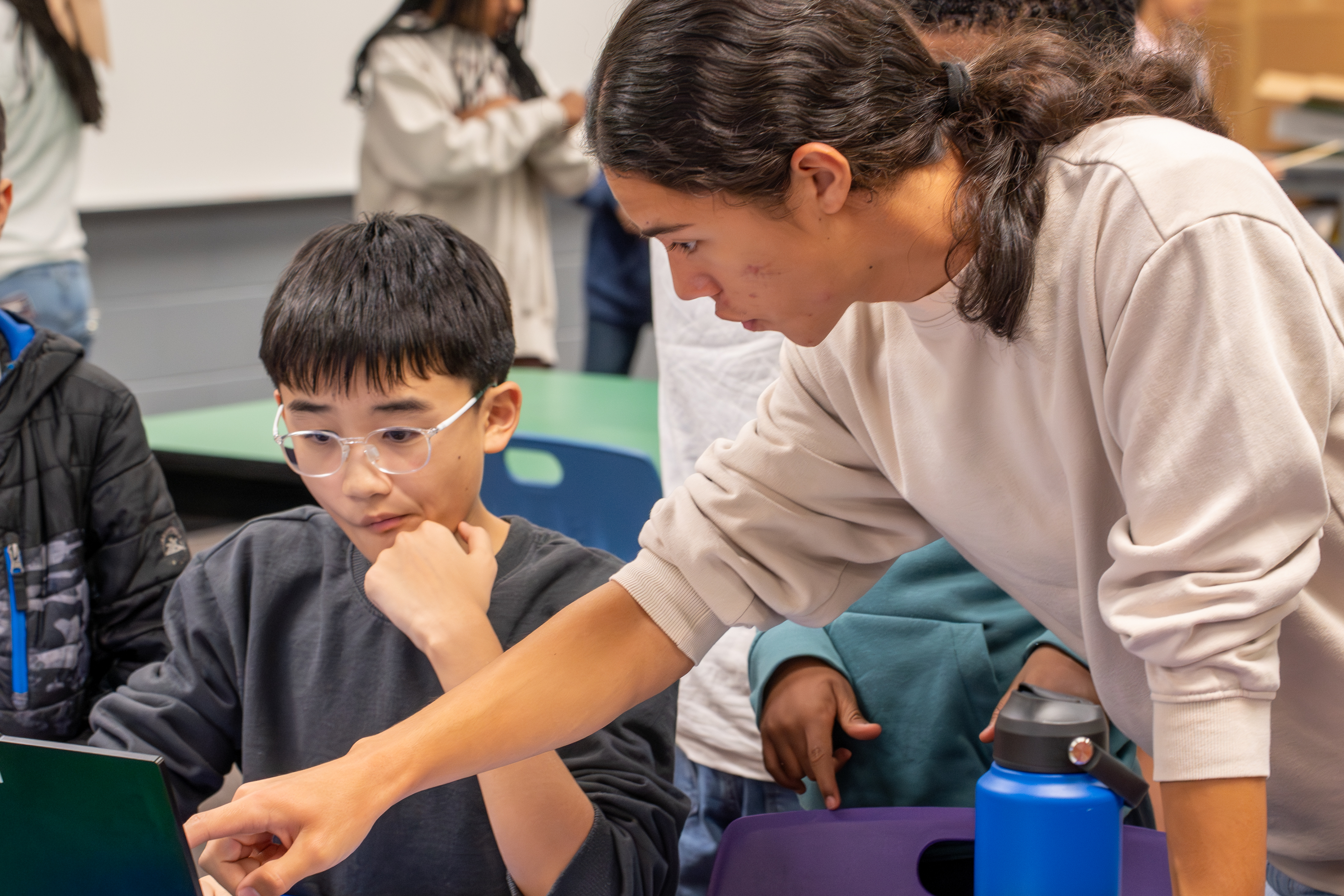 Students volunteering at a STEM activity
